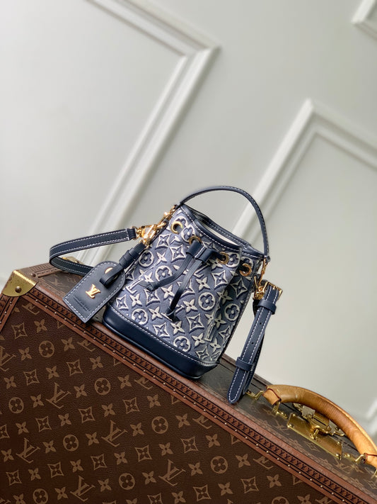 The bag inLouis Vuitton Nano Noé Monogram Emblème Blue jacquard textile edition.